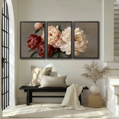 Large blush peonies and rust-colored flowers in a softly shaded arrangement 3 piece framed canvas wall art displayed in a entryway
