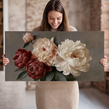Large blush peonies and rust-colored flowers in a softly shaded arrangement single canvas wall art held in hands