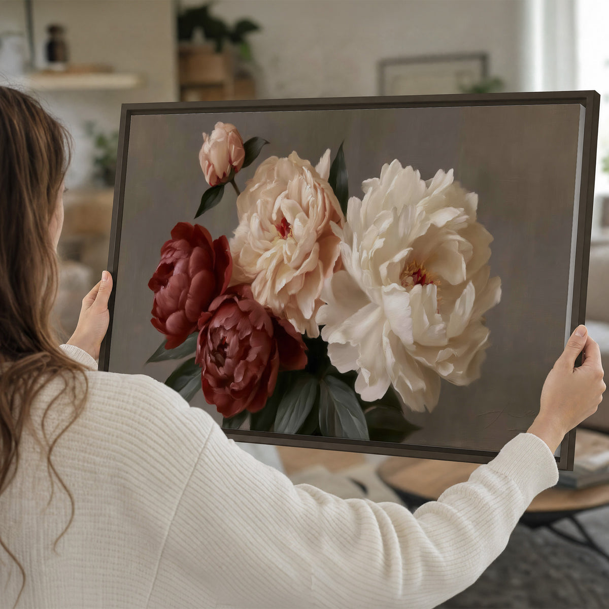 Large blush peonies and rust-colored flowers in a softly shaded arrangement single framed canvas wall art held in hands