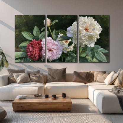 Cream, blush and red peonies surrounded by fresh green leaves 3 piece canvas wall art displayed in a living room
