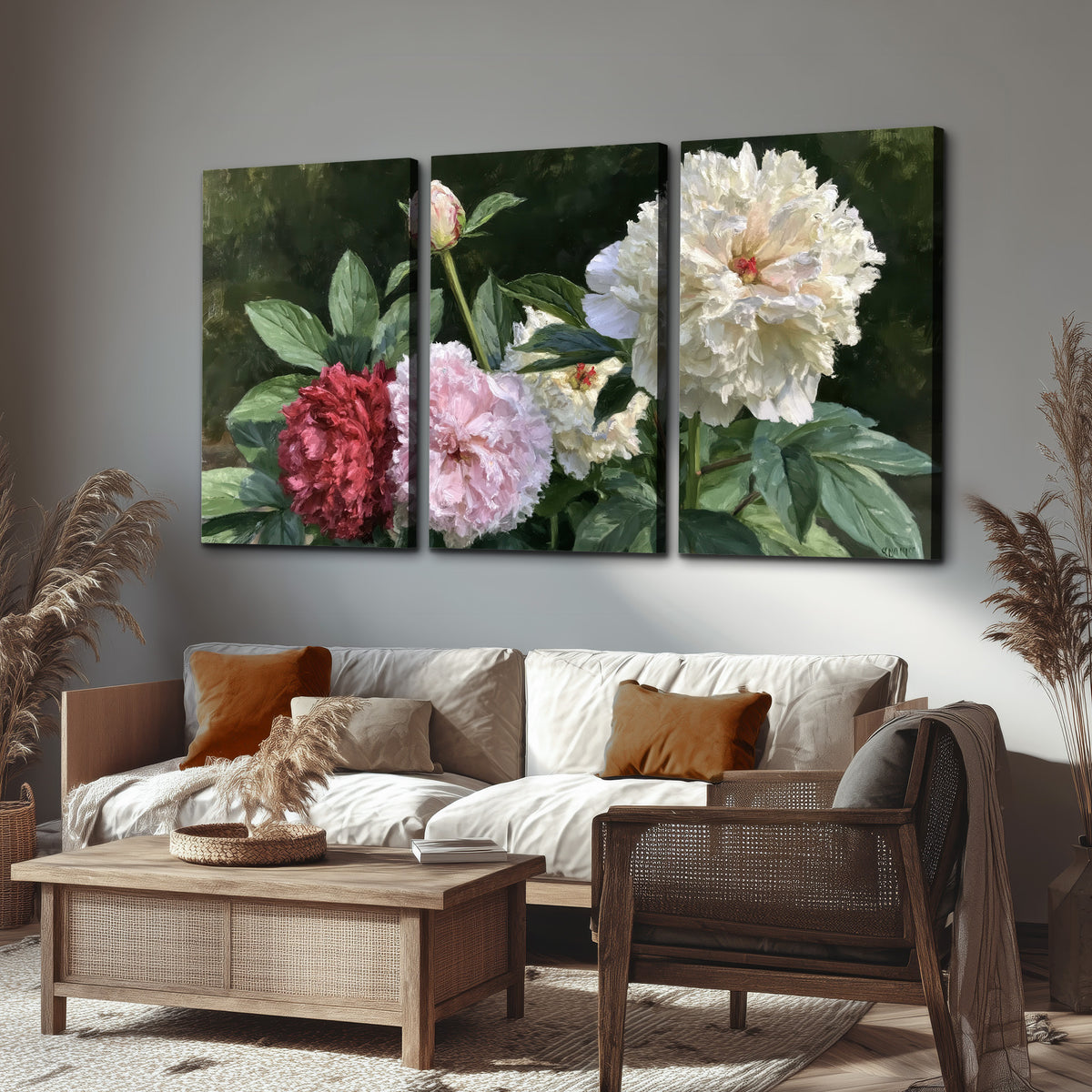 Cream, blush and red peonies surrounded by fresh green leaves 3 piece canvas wall art displayed in a rustic living room