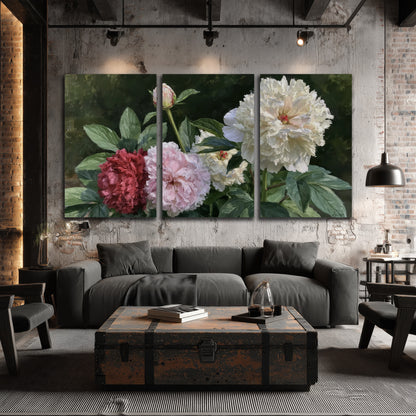 Cream, blush and red peonies surrounded by fresh green leaves 3 piece canvas wall art displayed in a industrial room