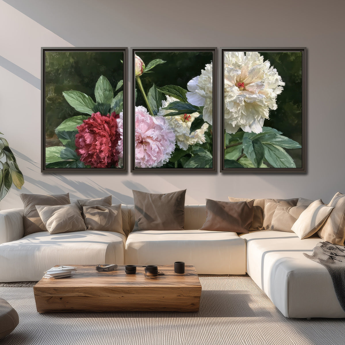 Cream, blush and red peonies surrounded by fresh green leaves 3 piece framed canvas wall art displayed in a living room