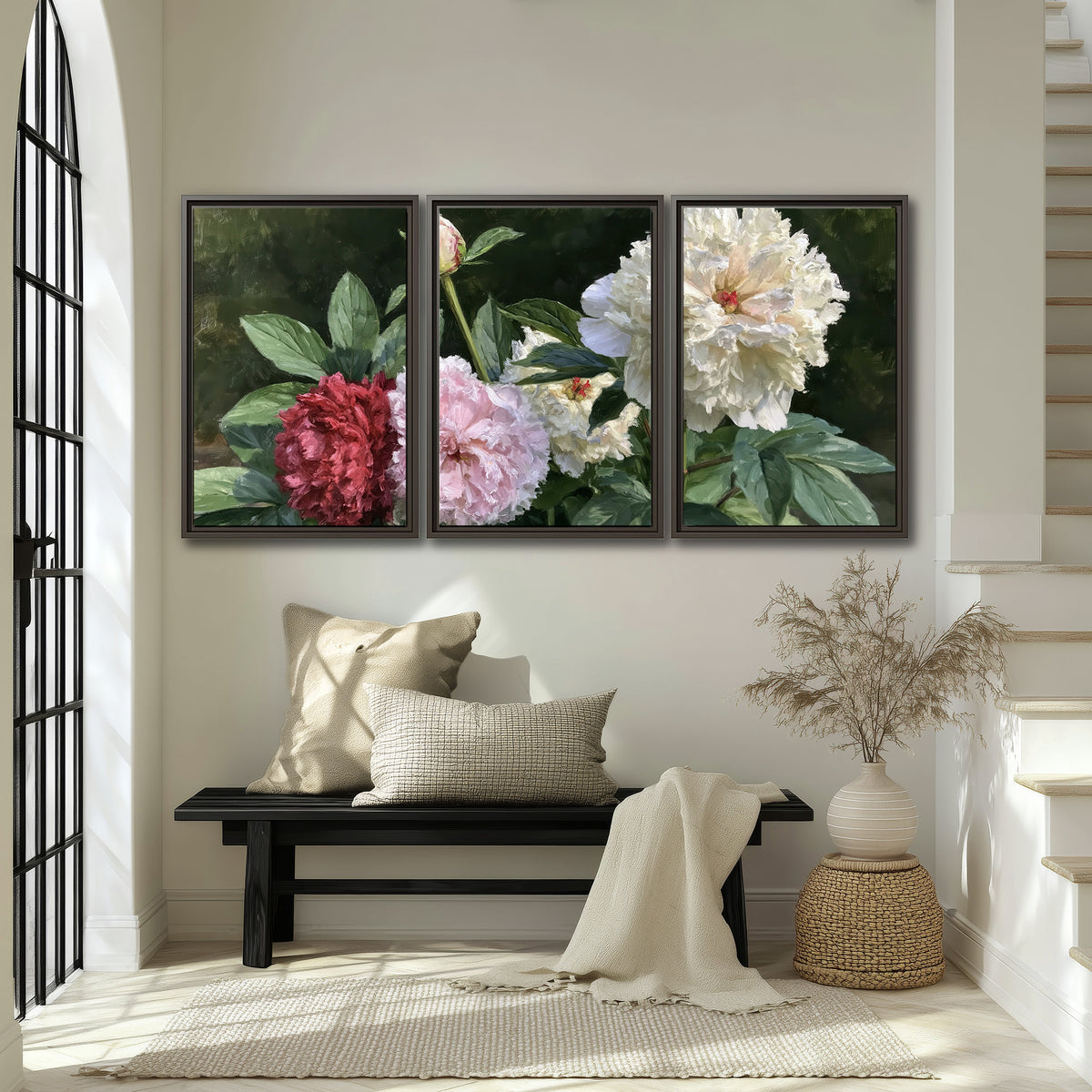 Cream, blush and red peonies surrounded by fresh green leaves 3 piece framed canvas wall art displayed in a entryway