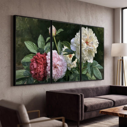 Cream, blush and red peonies surrounded by fresh green leaves 3 piece framed canvas wall art displayed in a modern living room