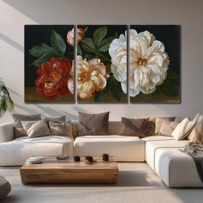 A large pale peony beside small ruby-red and peach flowers on a deep green ground 3 piece canvas wall art displayed in a living room