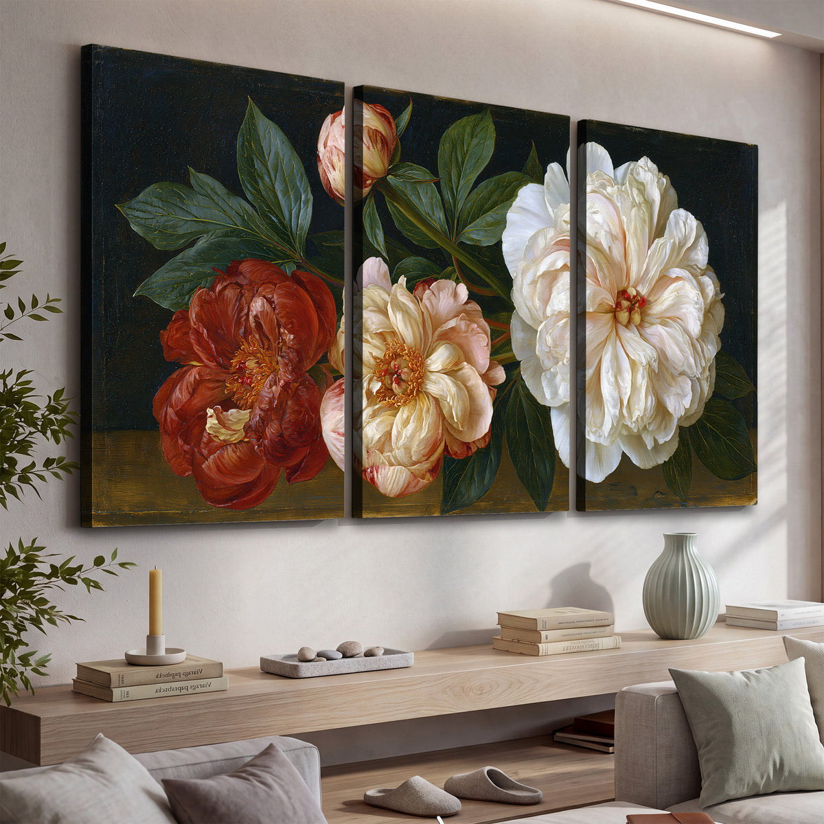 A large pale peony beside small ruby-red and peach flowers on a deep green ground 3 piece canvas wall art displayed in a console