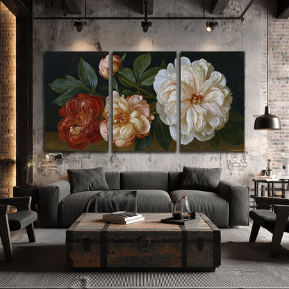 A large pale peony beside small ruby-red and peach flowers on a deep green ground 3 piece canvas wall art displayed in a industrial room