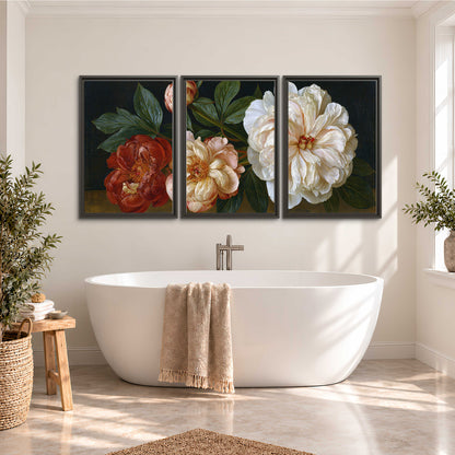A large pale peony beside small ruby-red and peach flowers on a deep green ground 3 piece framed canvas wall art styled in an interior