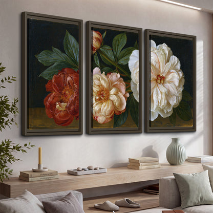 A large pale peony beside small ruby-red and peach flowers on a deep green ground 3 piece framed canvas wall art displayed in a console