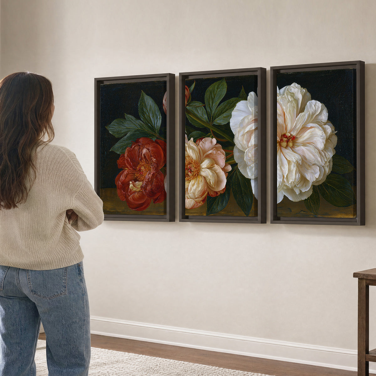 A large pale peony beside small ruby-red and peach flowers on a deep green ground 3 piece framed canvas wall art three panel arrangement on a wall