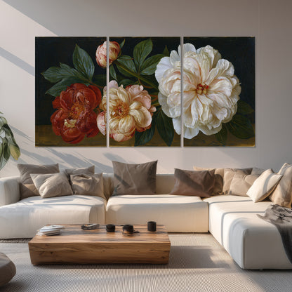 A large pale peony beside small ruby-red and peach flowers on a deep green ground set of 3 poster prints displayed in a living room