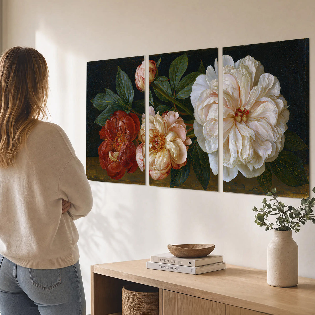 A large pale peony beside small ruby-red and peach flowers on a deep green ground set of 3 poster prints three panel arrangement on a wall