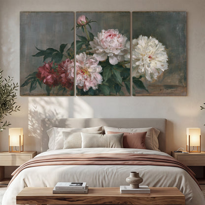 Cream and dusty pink peonies arranged against a muted gray-green background 3 piece canvas wall art displayed in a bedroom