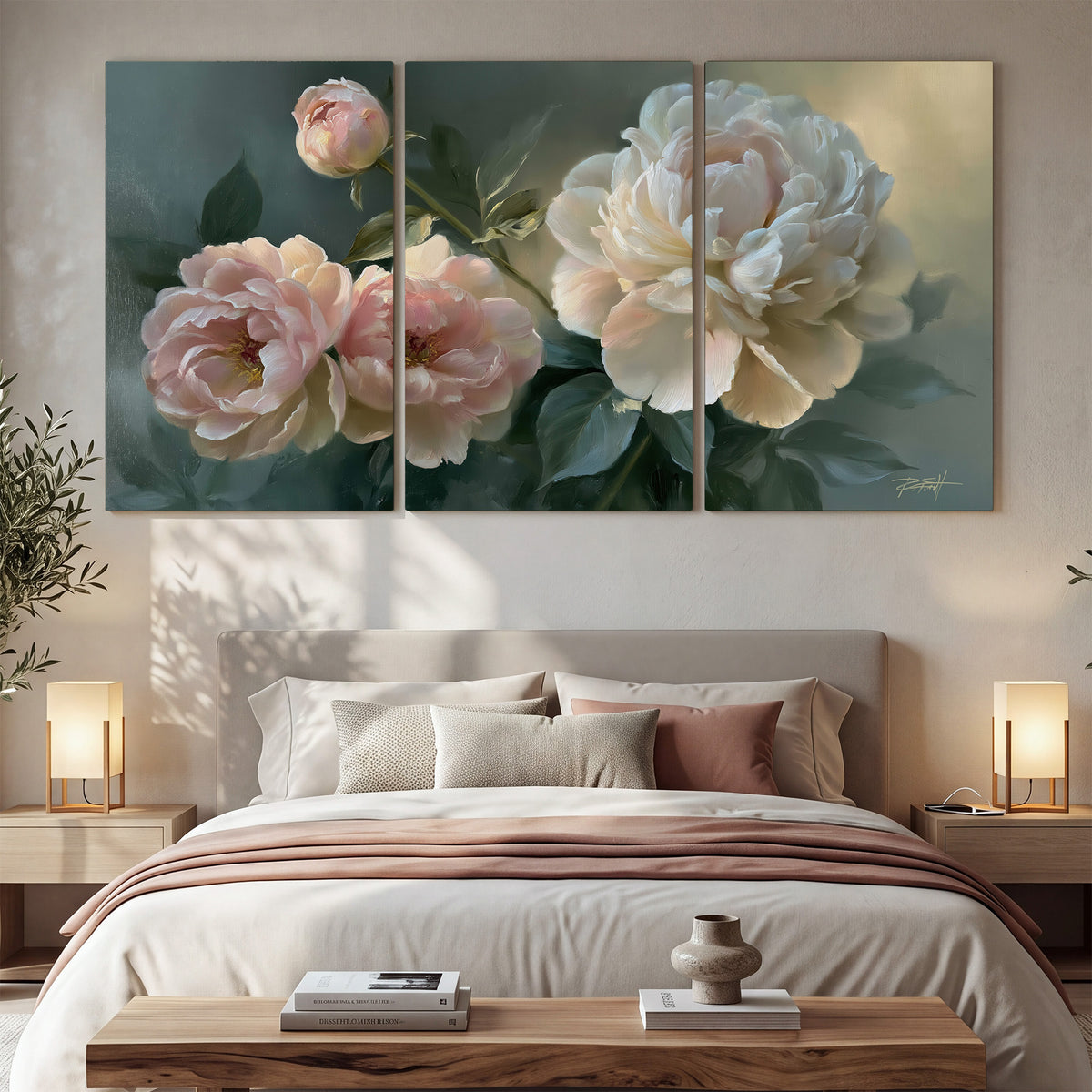 A large cream peony beside blush flowers and broad green leaves 3 piece canvas wall art displayed in a bedroom