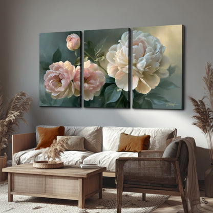 A large cream peony beside blush flowers and broad green leaves 3 piece canvas wall art displayed in a rustic living room