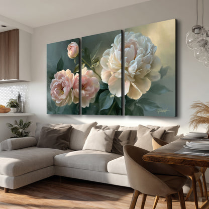 A large cream peony beside blush flowers and broad green leaves 3 piece canvas wall art room and product view