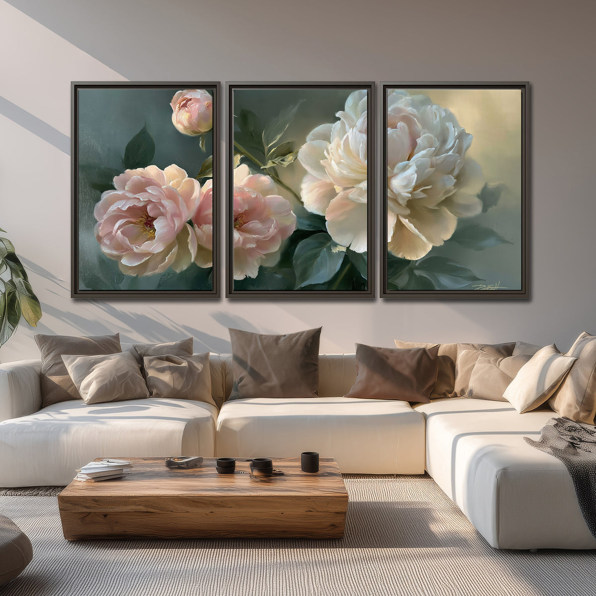 A large cream peony beside blush flowers and broad green leaves 3 piece framed canvas wall art displayed in a living room