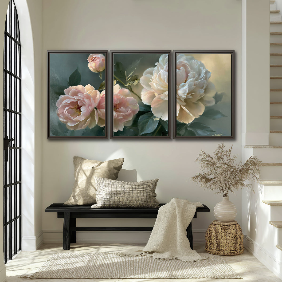 A large cream peony beside blush flowers and broad green leaves 3 piece framed canvas wall art displayed in a entryway