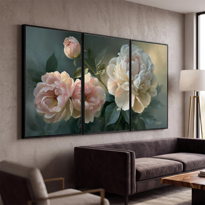 A large cream peony beside blush flowers and broad green leaves 3 piece framed canvas wall art displayed in a modern living room