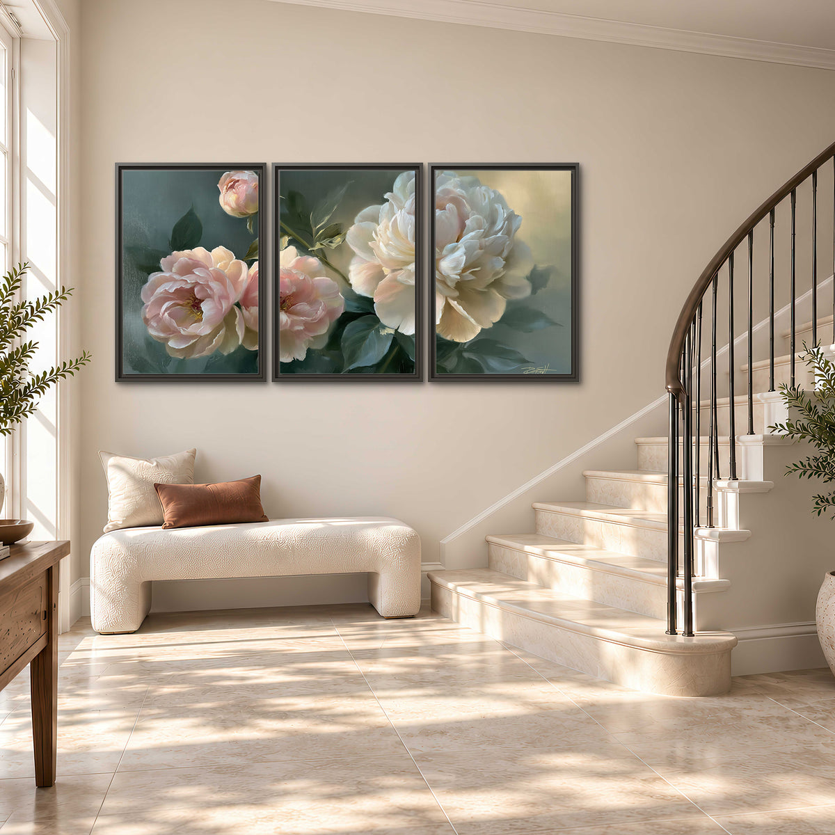 A large cream peony beside blush flowers and broad green leaves 3 piece framed canvas wall art styled in an interior
