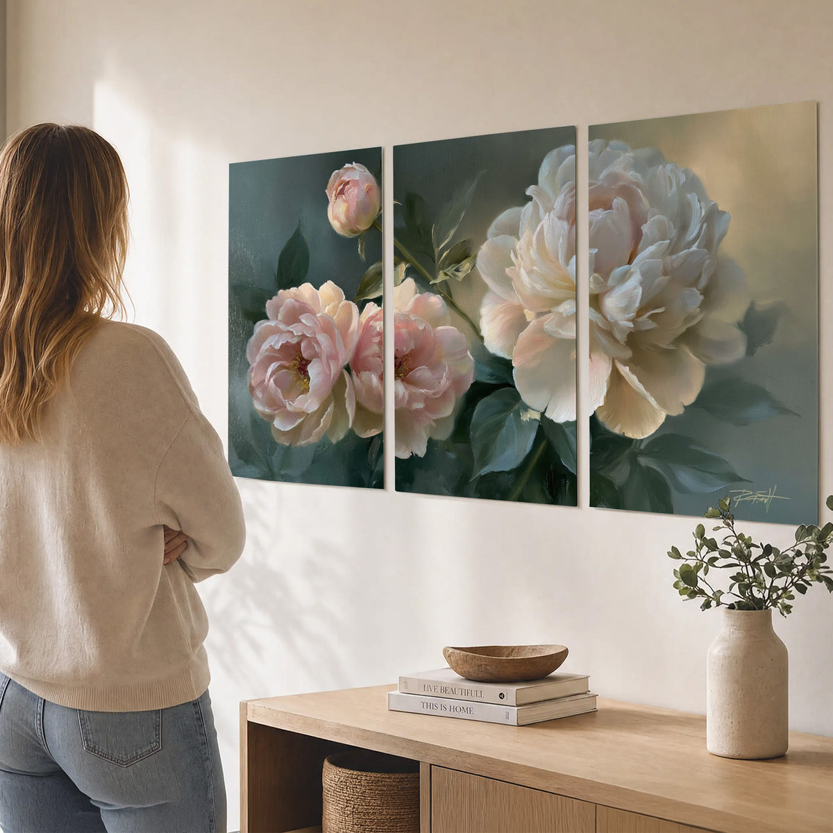 A large cream peony beside blush flowers and broad green leaves set of 3 poster prints three panel arrangement on a wall