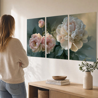 A large cream peony beside blush flowers and broad green leaves set of 3 poster prints three panel arrangement on a wall