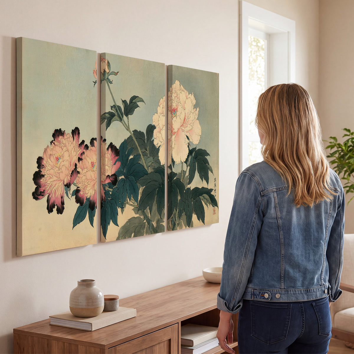 Pink and cream peonies with dark green leaves on a warm beige ground 3 piece canvas wall art three panel arrangement on a wall