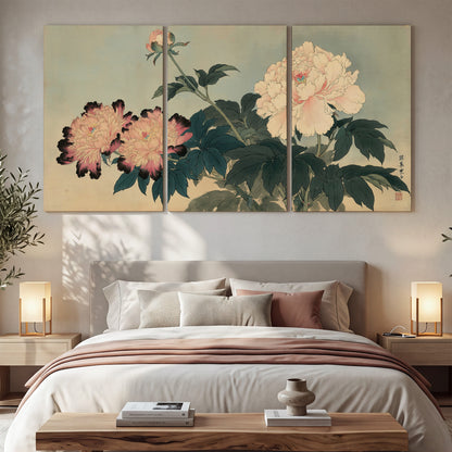 Pink and cream peonies with dark green leaves on a warm beige ground 3 piece canvas wall art displayed in a bedroom