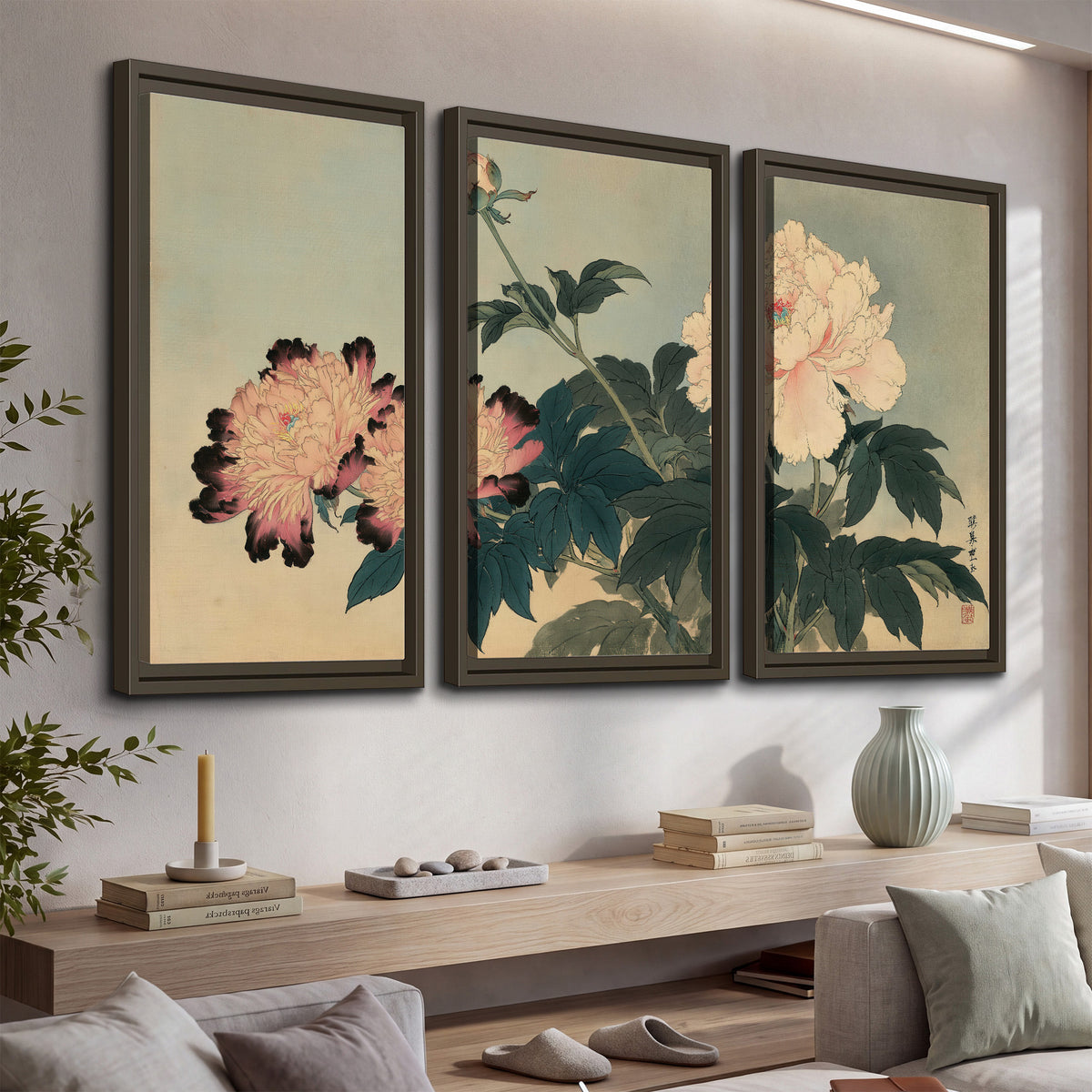 Pink and cream peonies with dark green leaves on a warm beige ground 3 piece framed canvas wall art displayed in a console