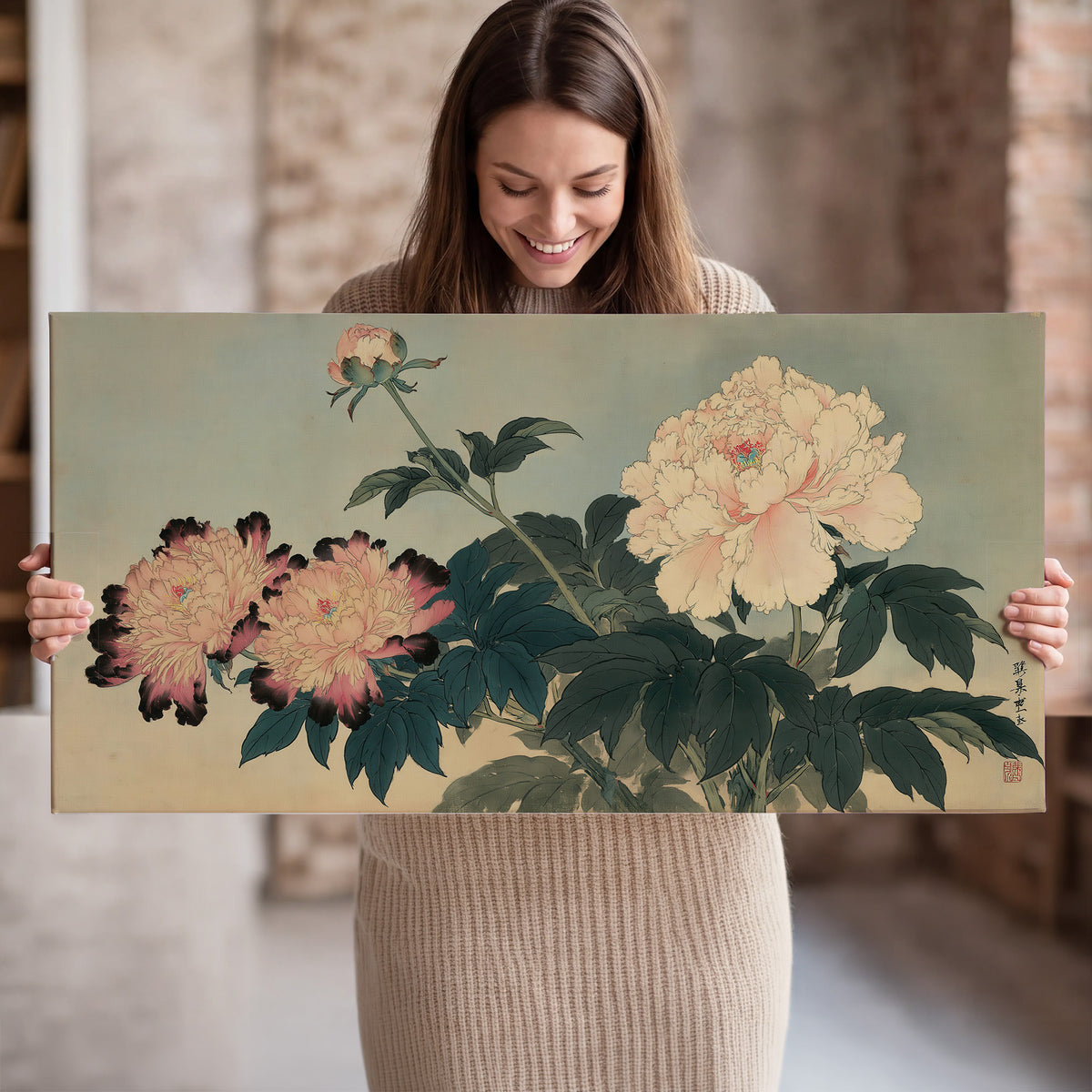 Pink and cream peonies with dark green leaves on a warm beige ground single canvas wall art held in hands