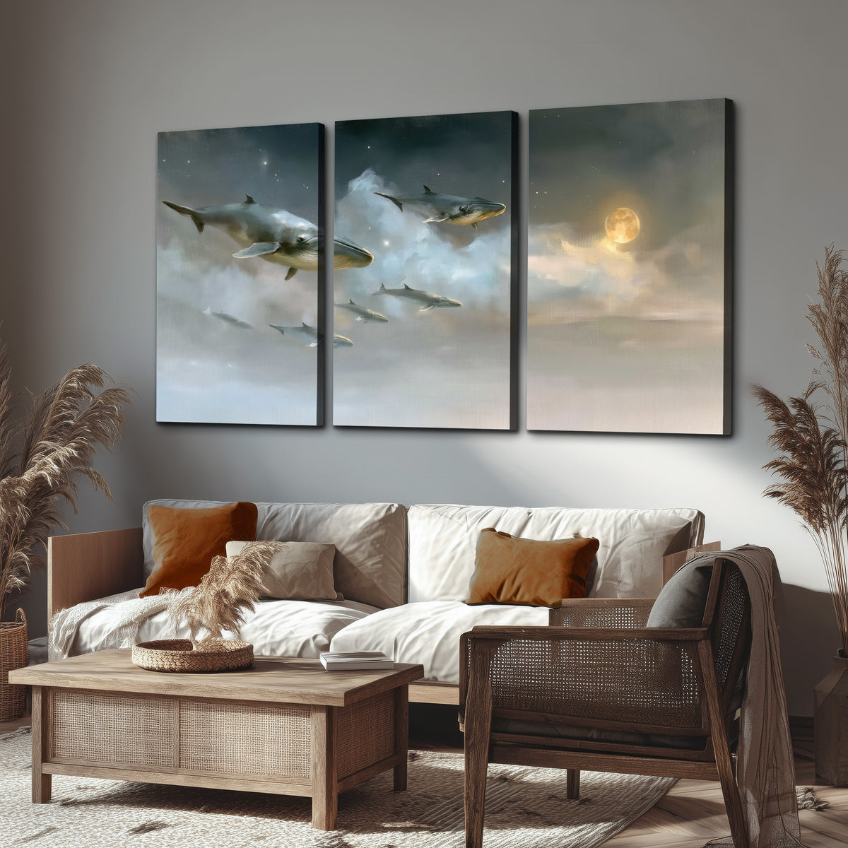 Whales drifting through pale dreamlike clouds toward a golden moon 3 piece canvas wall art displayed in a rustic living room