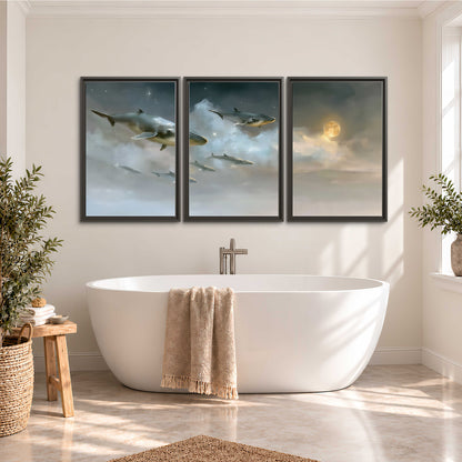 Whales drifting through pale dreamlike clouds toward a golden moon 3 piece framed canvas wall art styled in an interior