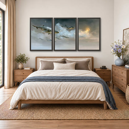 Whales drifting through pale dreamlike clouds toward a golden moon 3 piece framed canvas wall art styled in an interior