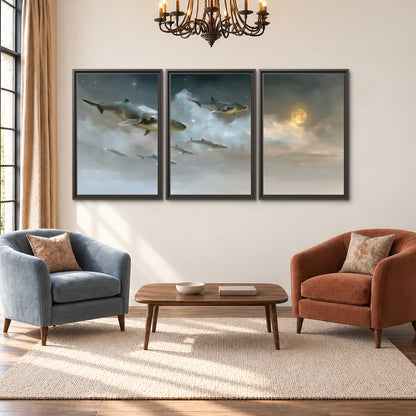 Whales drifting through pale dreamlike clouds toward a golden moon 3 piece framed canvas wall art styled in an interior