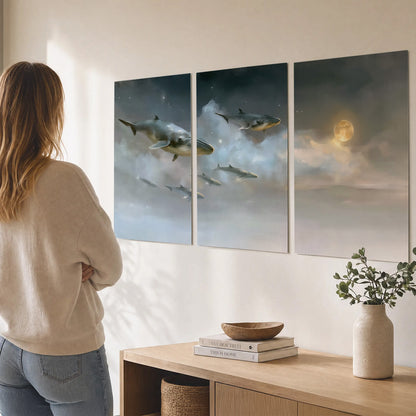 Whales drifting through pale dreamlike clouds toward a golden moon set of 3 poster prints three panel arrangement on a wall