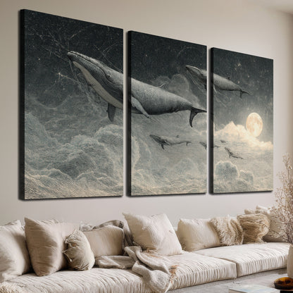 Monochrome whales floating over misty clouds beside a luminous painted moon 3 piece canvas wall art room and product view