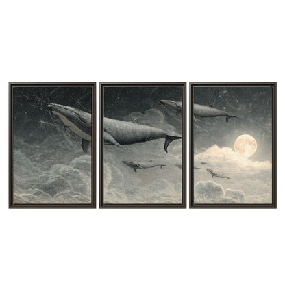 Monochrome whales floating over misty clouds beside a luminous painted moon 3 piece framed canvas wall art viewed straight on
