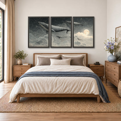 Monochrome whales floating over misty clouds beside a luminous painted moon 3 piece framed canvas wall art styled in an interior