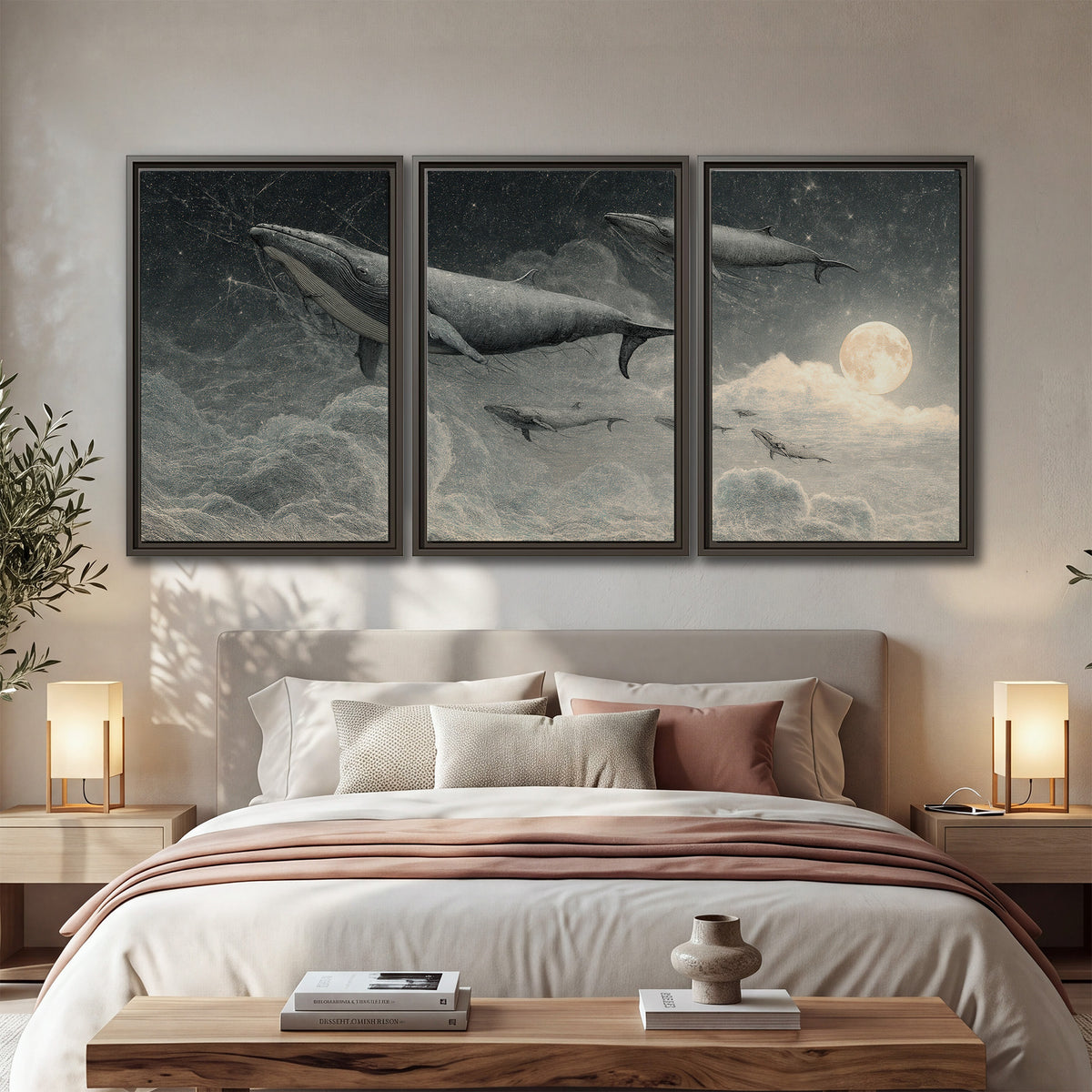 Monochrome whales floating over misty clouds beside a luminous painted moon 3 piece framed canvas wall art displayed in a bedroom