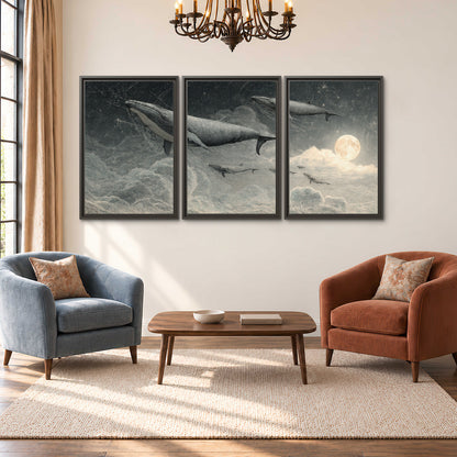 Monochrome whales floating over misty clouds beside a luminous painted moon 3 piece framed canvas wall art styled in an interior