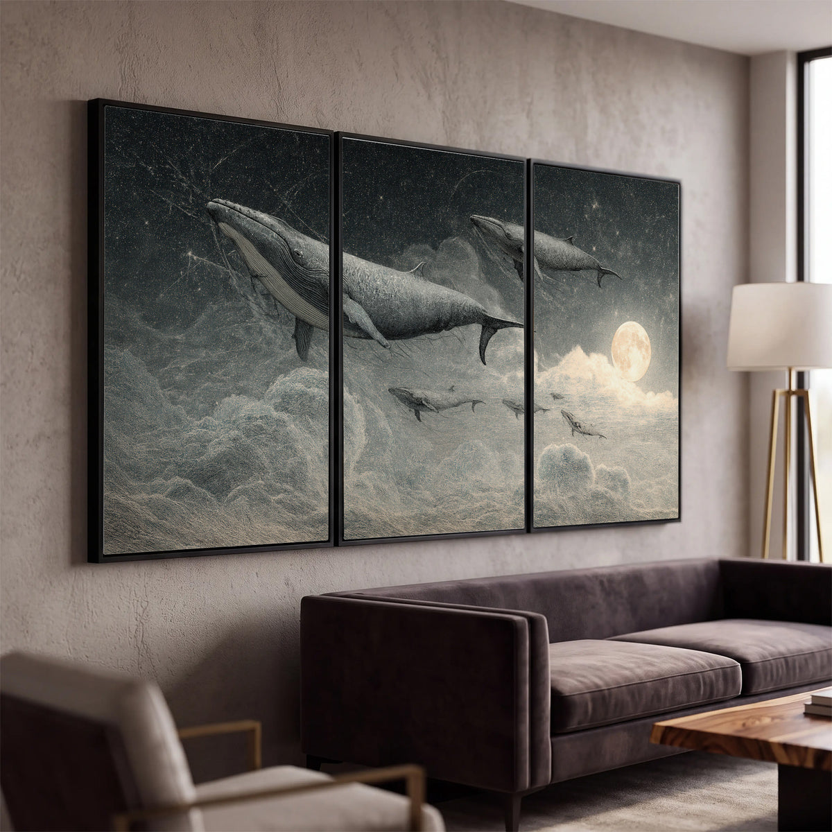 Monochrome whales floating over misty clouds beside a luminous painted moon 3 piece framed canvas wall art displayed in a modern living room