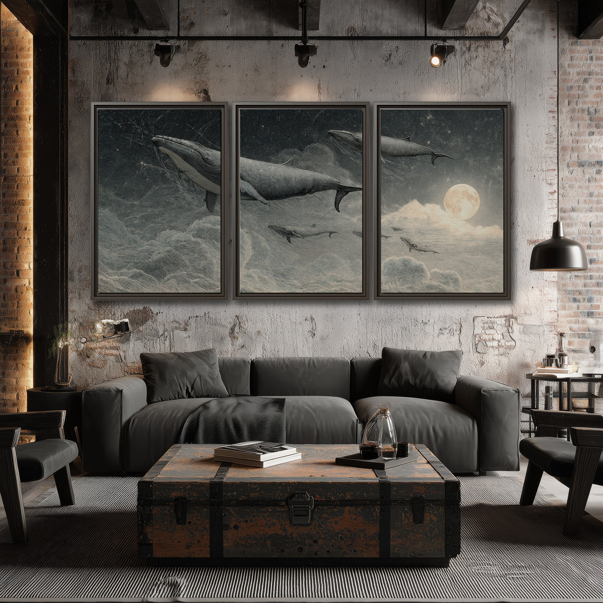 Monochrome whales floating over misty clouds beside a luminous painted moon 3 piece framed canvas wall art displayed in a industrial room