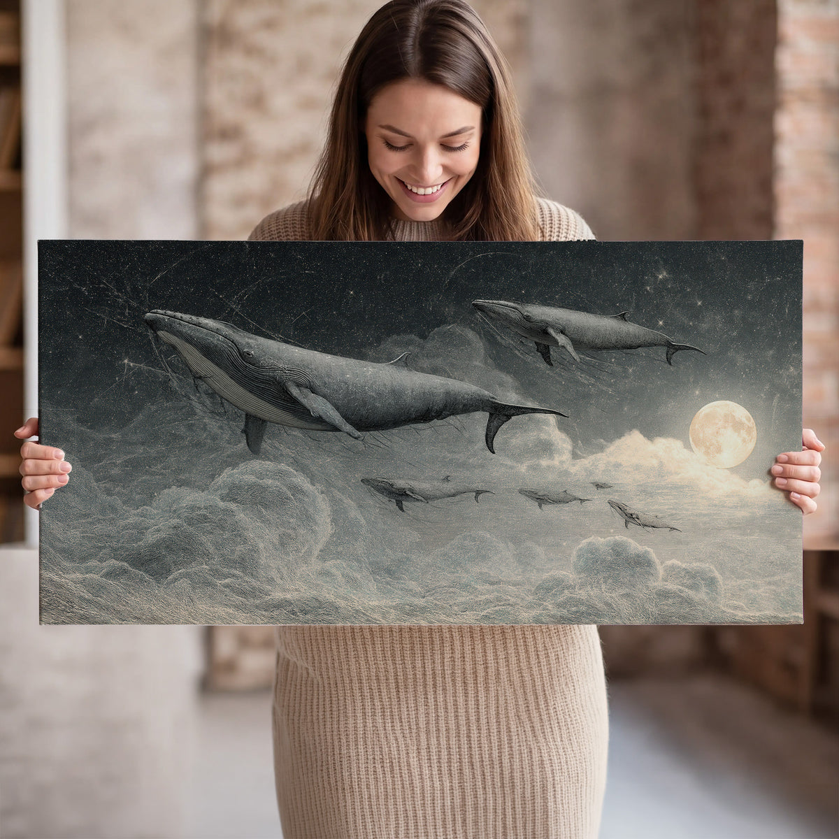 Monochrome whales floating over misty clouds beside a luminous painted moon single canvas wall art held in hands