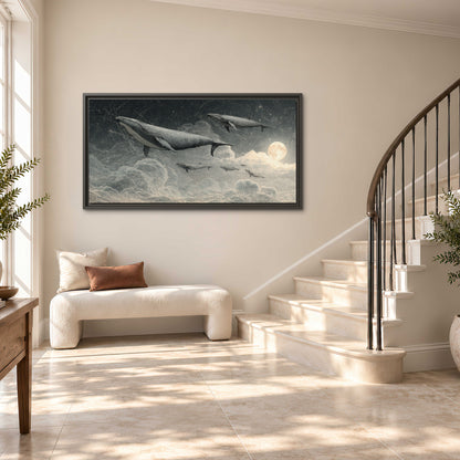 Monochrome whales floating over misty clouds beside a luminous painted moon single framed canvas wall art styled in an interior