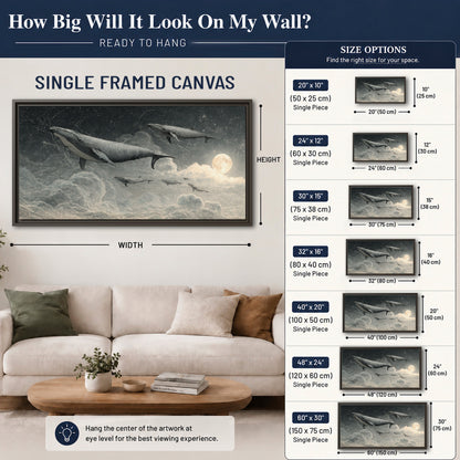 Monochrome whales floating over misty clouds beside a luminous painted moon single framed canvas wall art size guide above a sofa; room view is illustrative