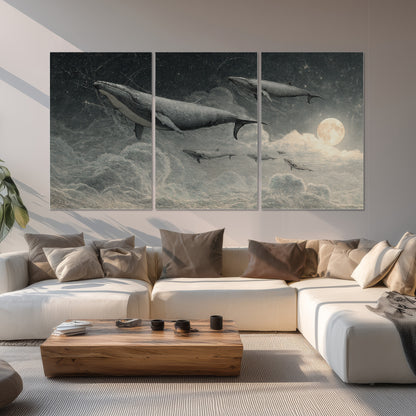 Monochrome whales floating over misty clouds beside a luminous painted moon set of 3 poster prints displayed in a living room