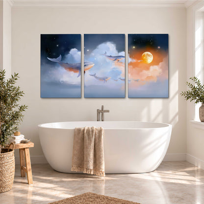 Blue whales gliding through pastel clouds beneath stars and a warm orange moon 3 piece canvas wall art styled in an interior
