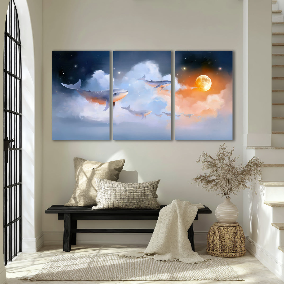 Blue whales gliding through pastel clouds beneath stars and a warm orange moon 3 piece canvas wall art displayed in a entryway
