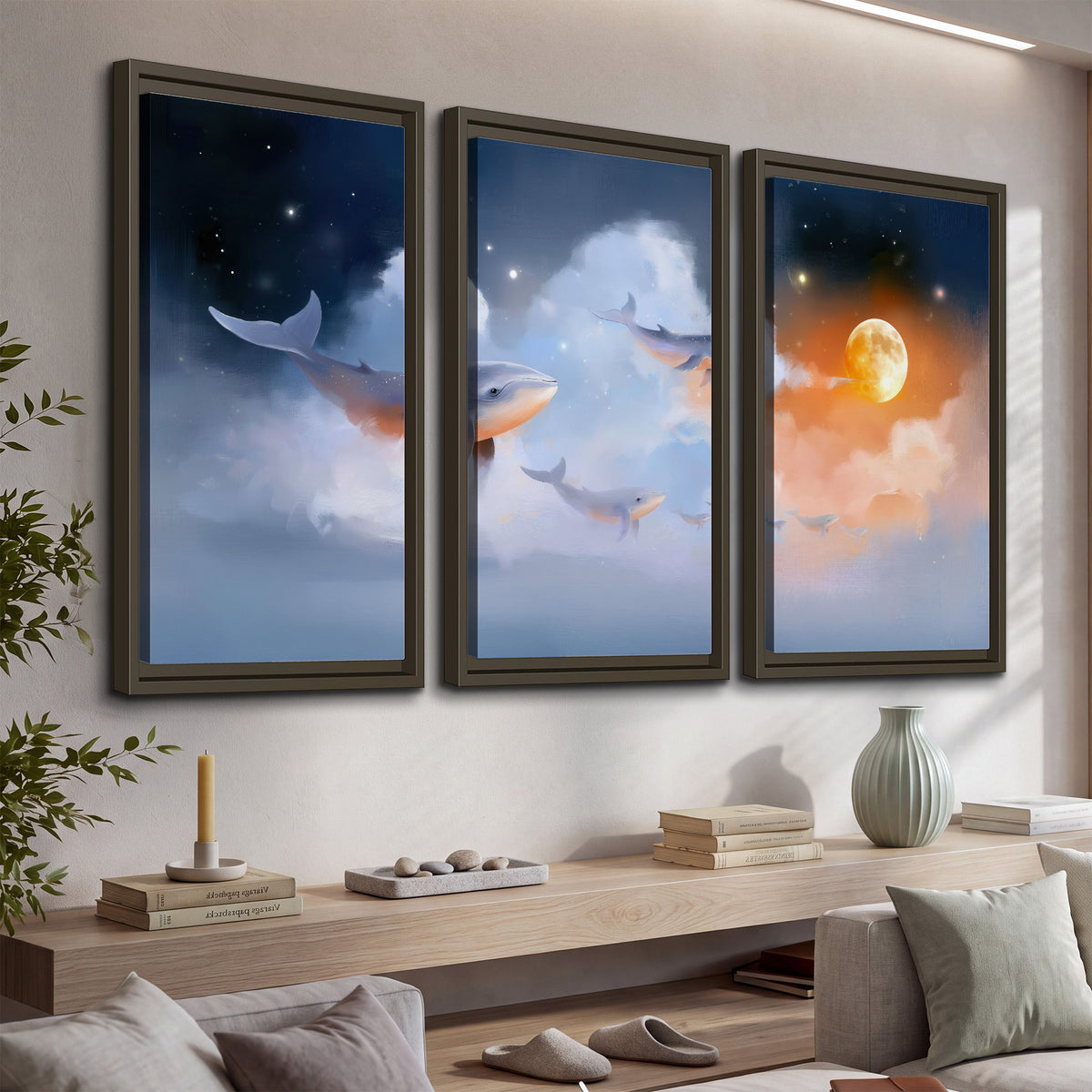 Blue whales gliding through pastel clouds beneath stars and a warm orange moon 3 piece framed canvas wall art displayed in a console